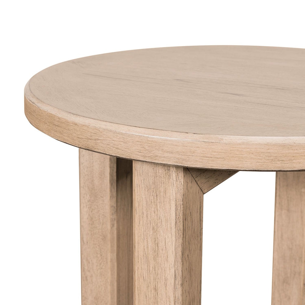Close-up top view of the Proximity Place chairside table showing its round light wood finish surface.