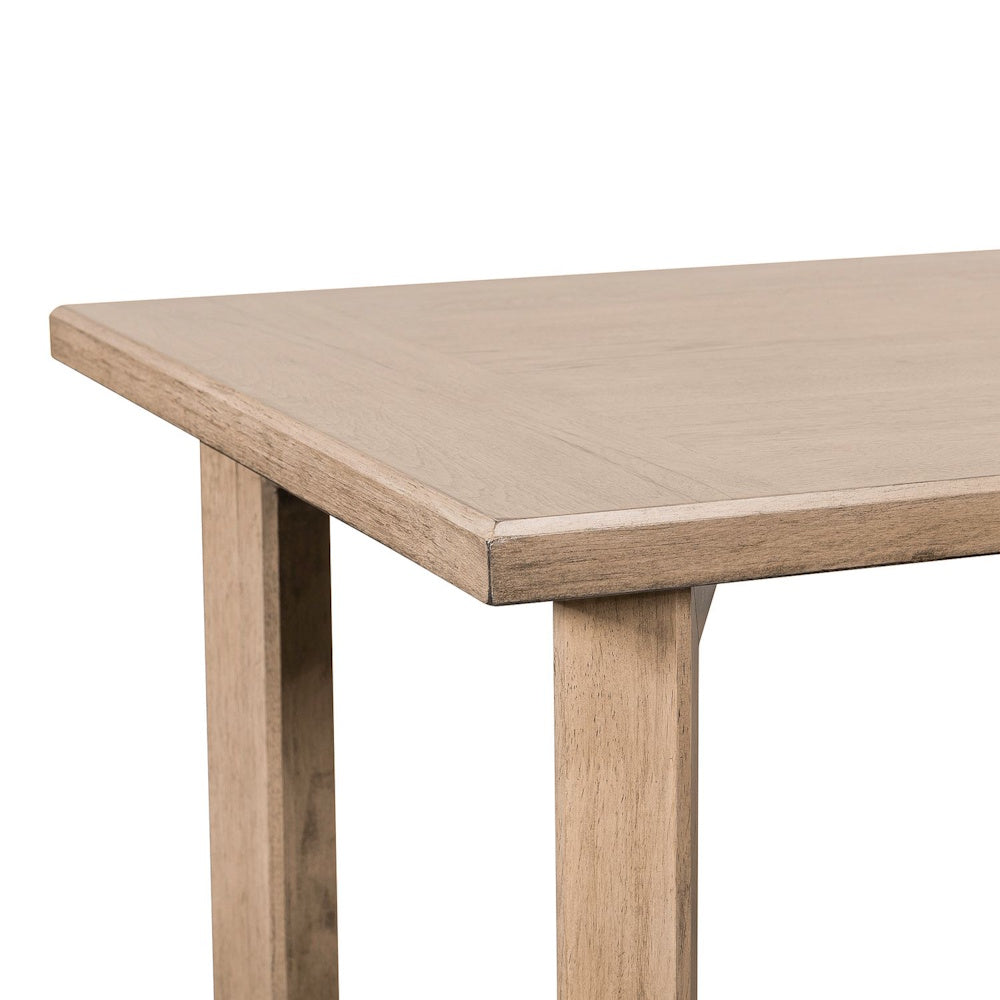 Close-up of a light brown wooden sofa table corner with a smooth tabletop and square legs.