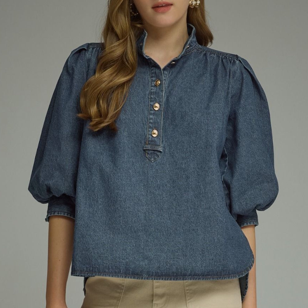 Front view of a dark blue denim top featuring puff sleeves, a stand collar, and button placket.