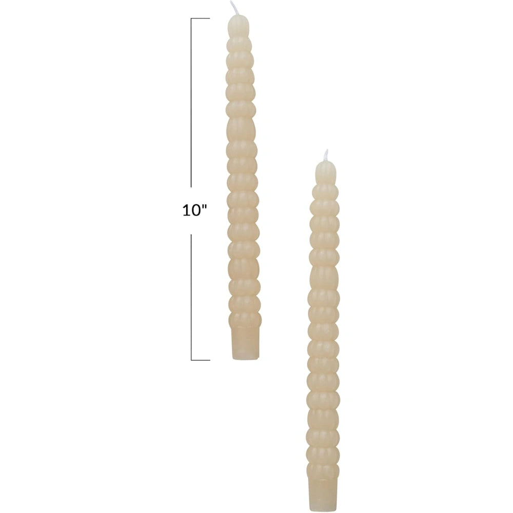 Two ivory-colored, textured taper candles against a white background, with a 10" height measurement marked.