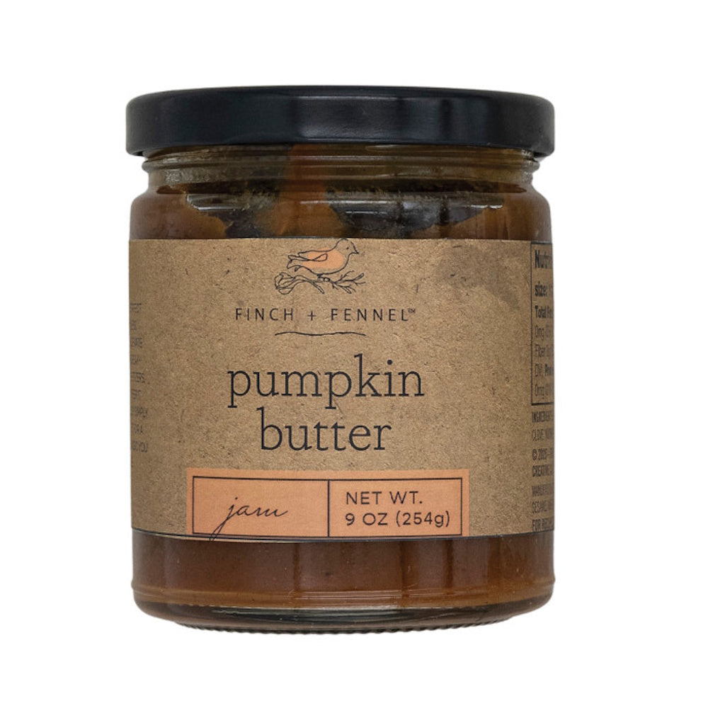 A jar of Finch + Fennel pumpkin butter jam featuring a brown kraft paper label and black lid.