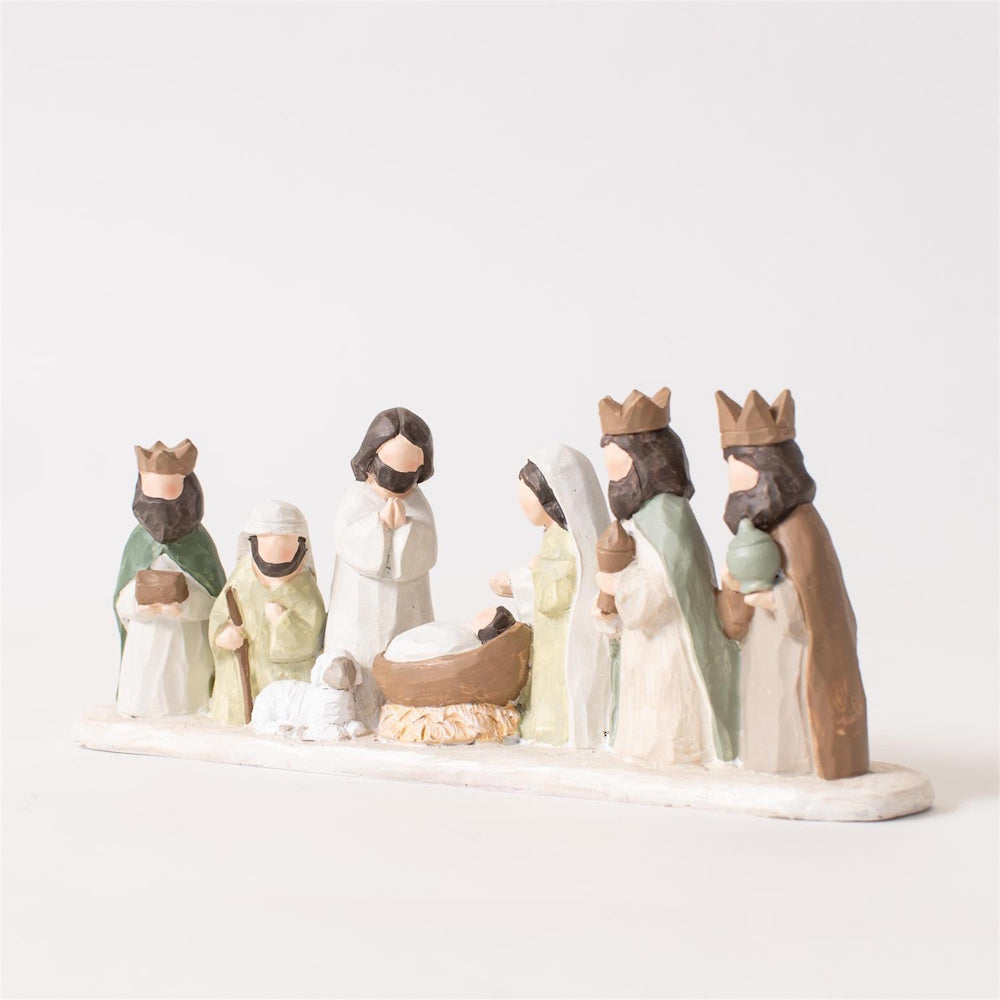 Minimalist nativity figurine set featuring baby Jesus, Mary, Joseph, three wise men, and a lamb.
