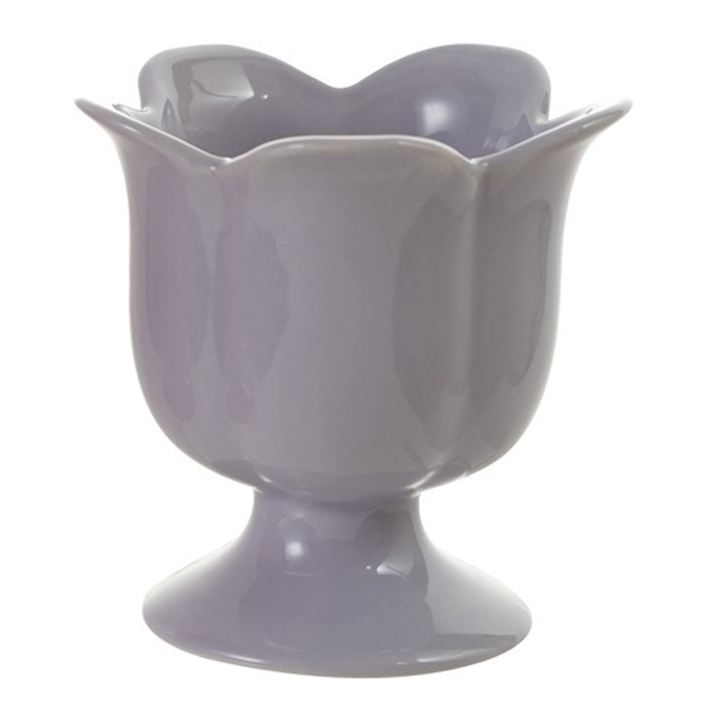 A glossy lavender ceramic footed cup with a scalloped flower-petal rim on a white background.