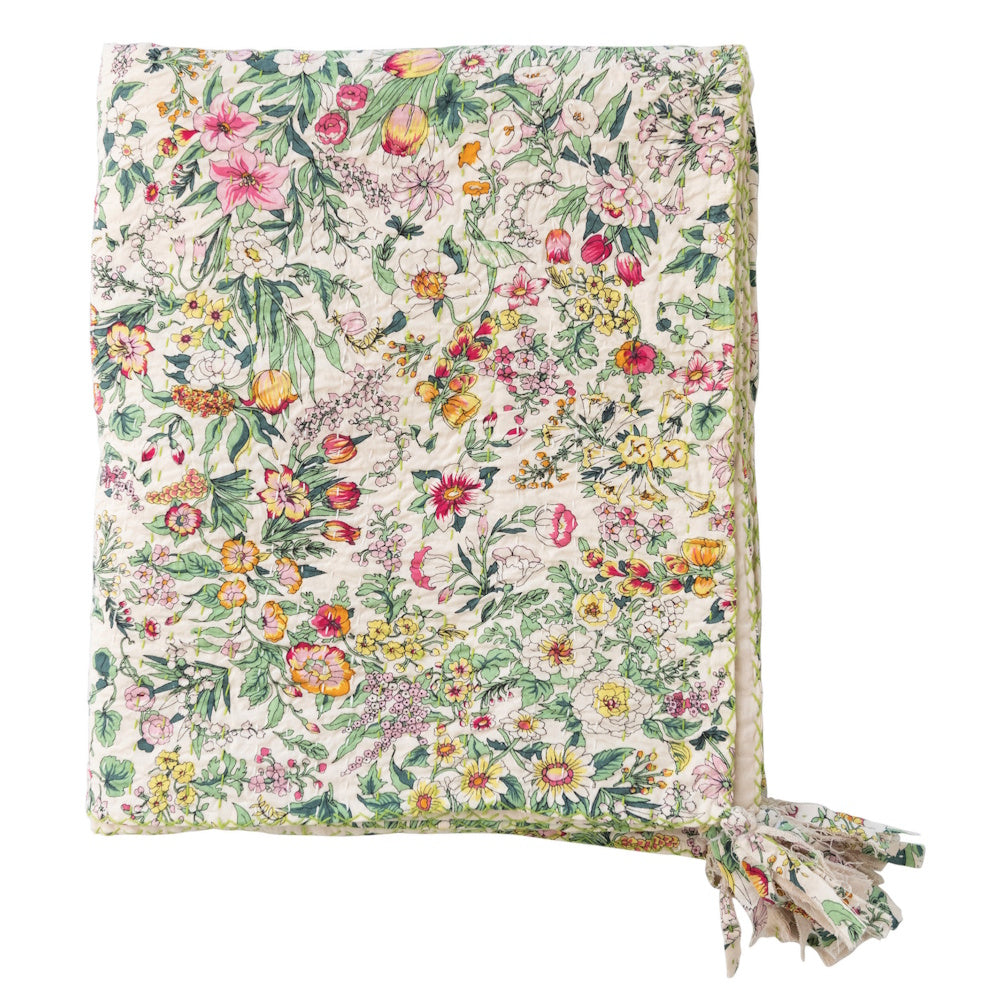Quilted cotton floral throw blanket with kantha stitching and decorative tassels on a white background.
