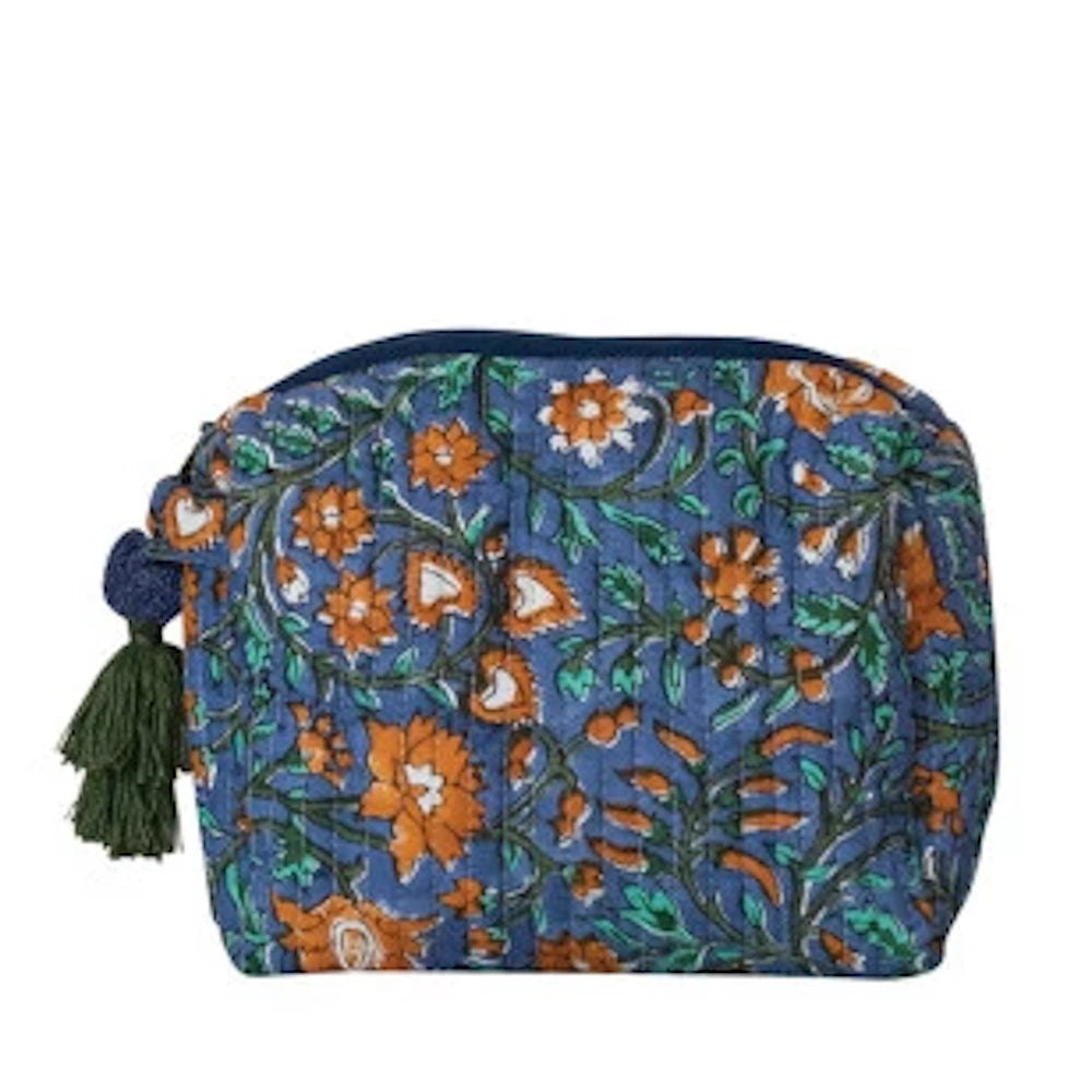 Blue floral quilted cotton zip pouch with orange flowers and a green tassel against a white background.