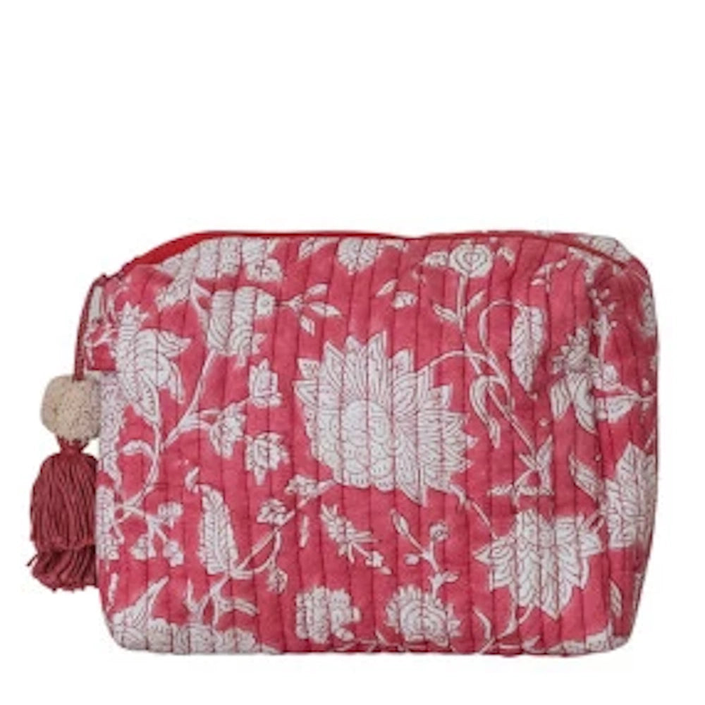 Pink quilted cotton floral zip pouch with a white flower pattern and matching tassel zipper pull on a white background.