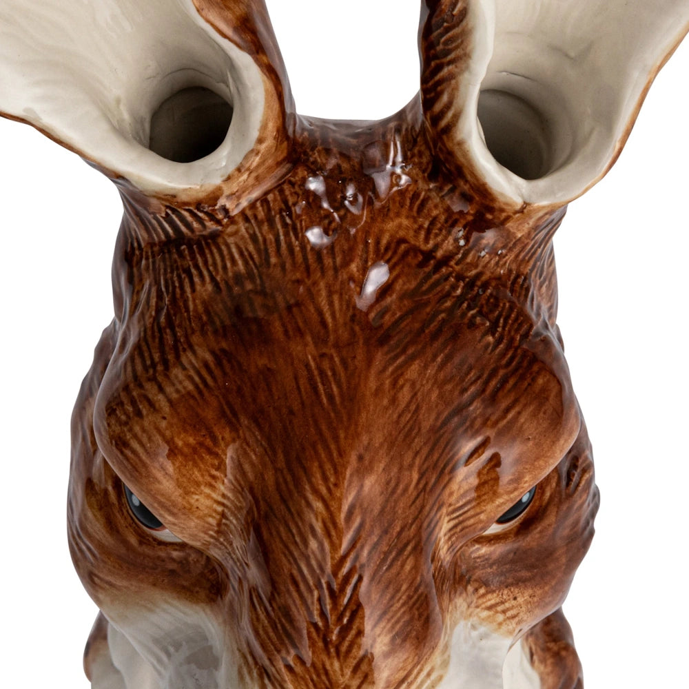 Close-up of a hand-painted rabbit stoneware vase showing dual openings in the ears for flowers.