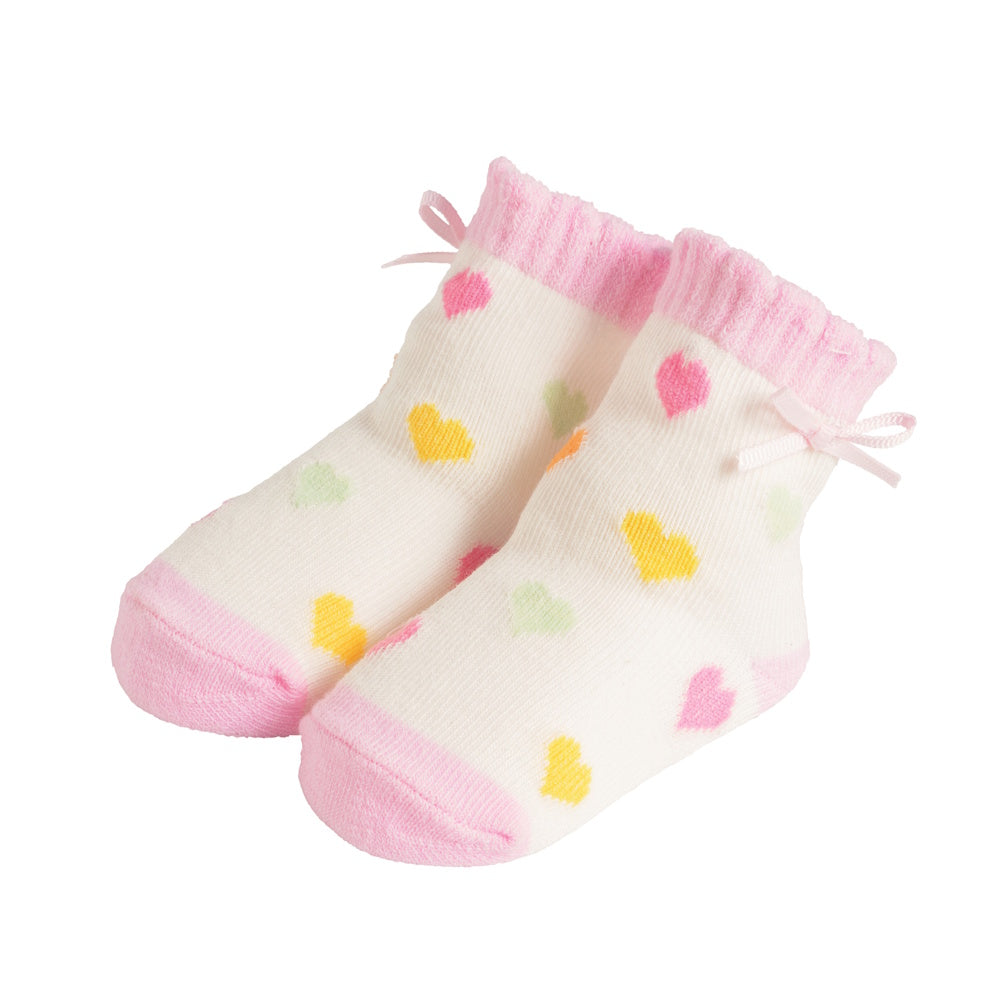 White baby socks with pink trim and colorful heart patterns, featuring small pink satin bows on the ribbed cuffs.