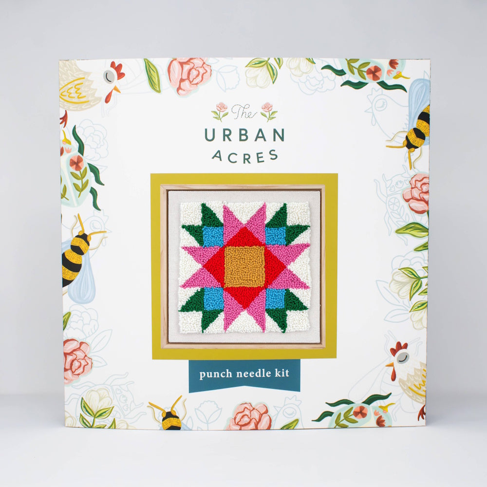 The Urban Acres punch needle kit packaging displaying a colorful geometric quilt star design.