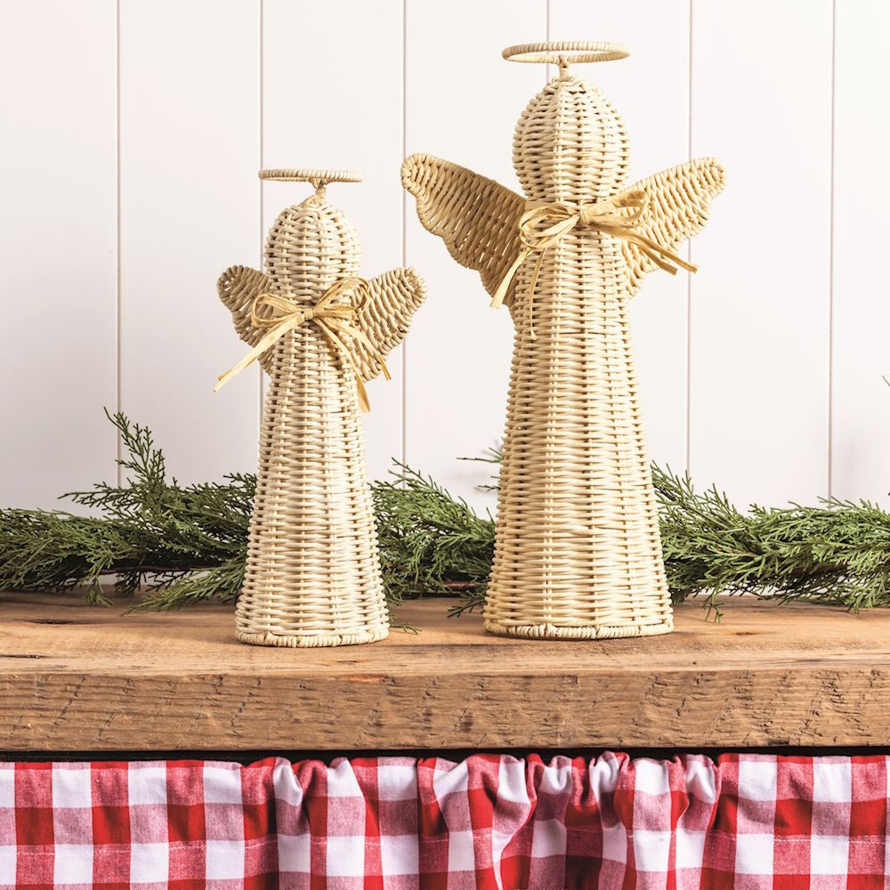 Two woven rattan angel figurines with halos and bows standing on a wooden surface.