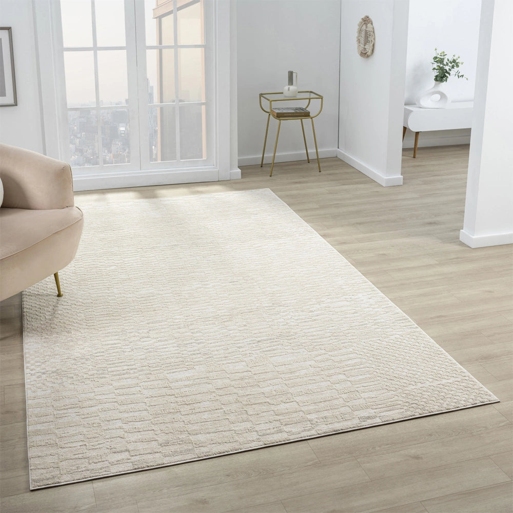 Cream geometric area rug in a bright modern living room with textured pattern and subtle high low weave design.