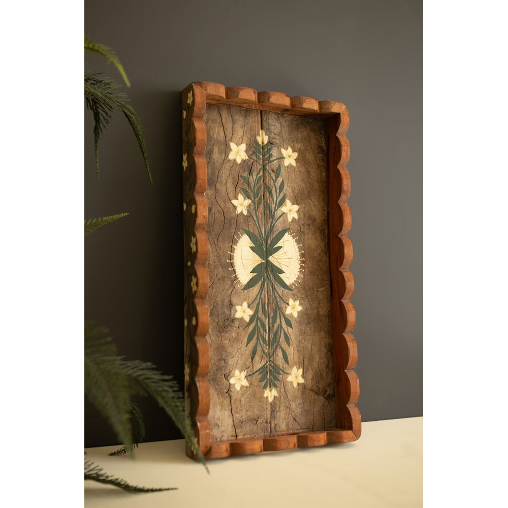 Scalloped wooden tray leaning upright, displaying hand-painted botanical artwork on rustic wood.