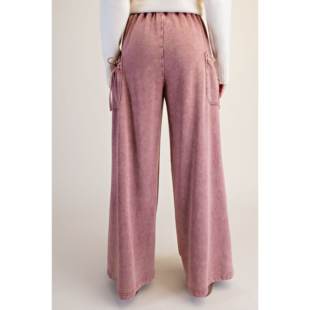 Back view of dusty rose washed terry knit wide-leg pants with elastic waistband and side cargo pockets.