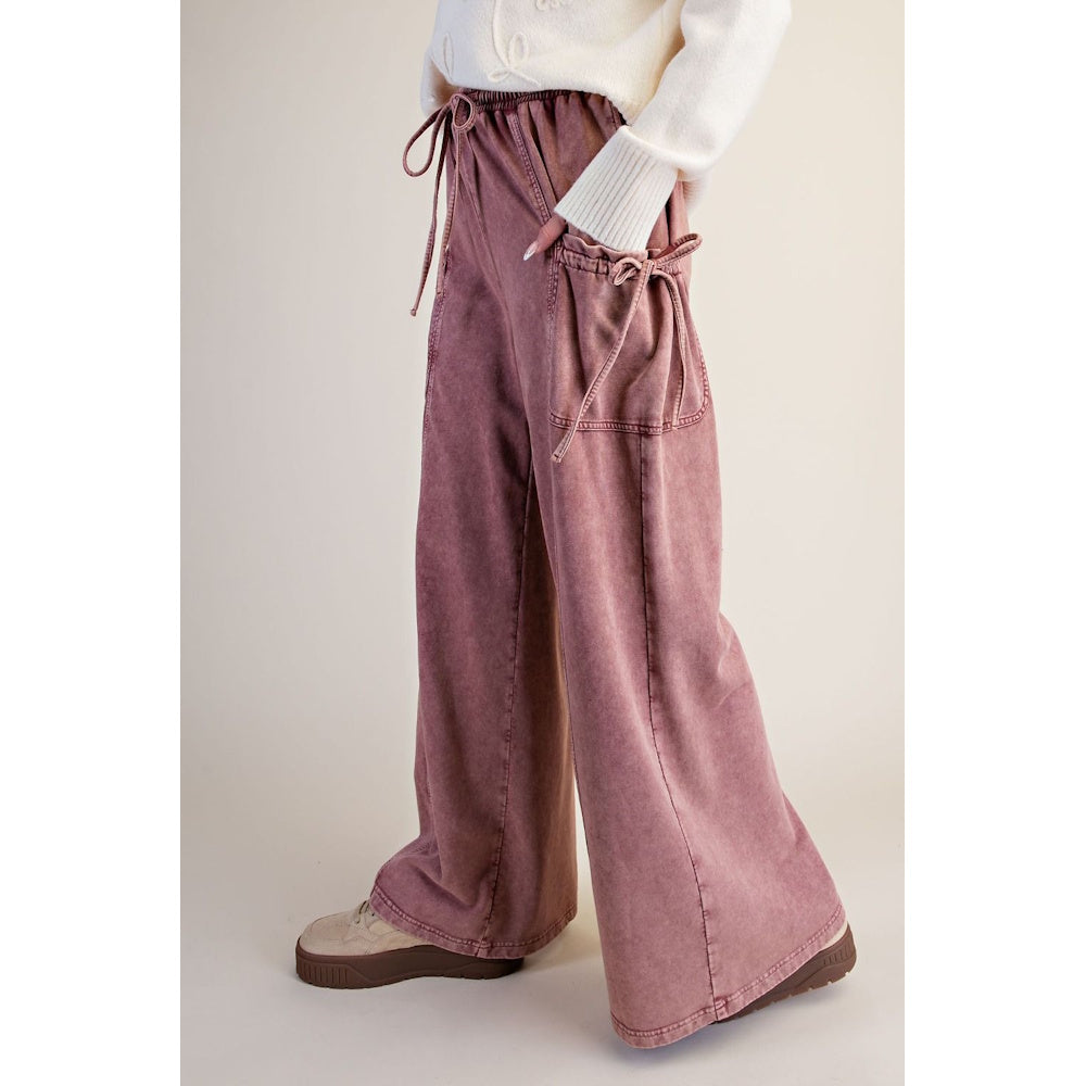 Side view of dusty rose washed terry knit wide-leg pants with tie-accent cargo pockets.