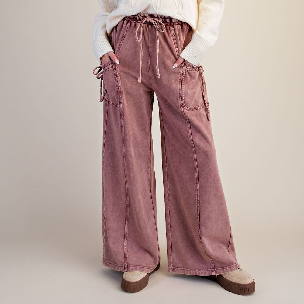 Dusty rose washed terry knit wide-leg pants with drawstring waist and cargo pockets.
