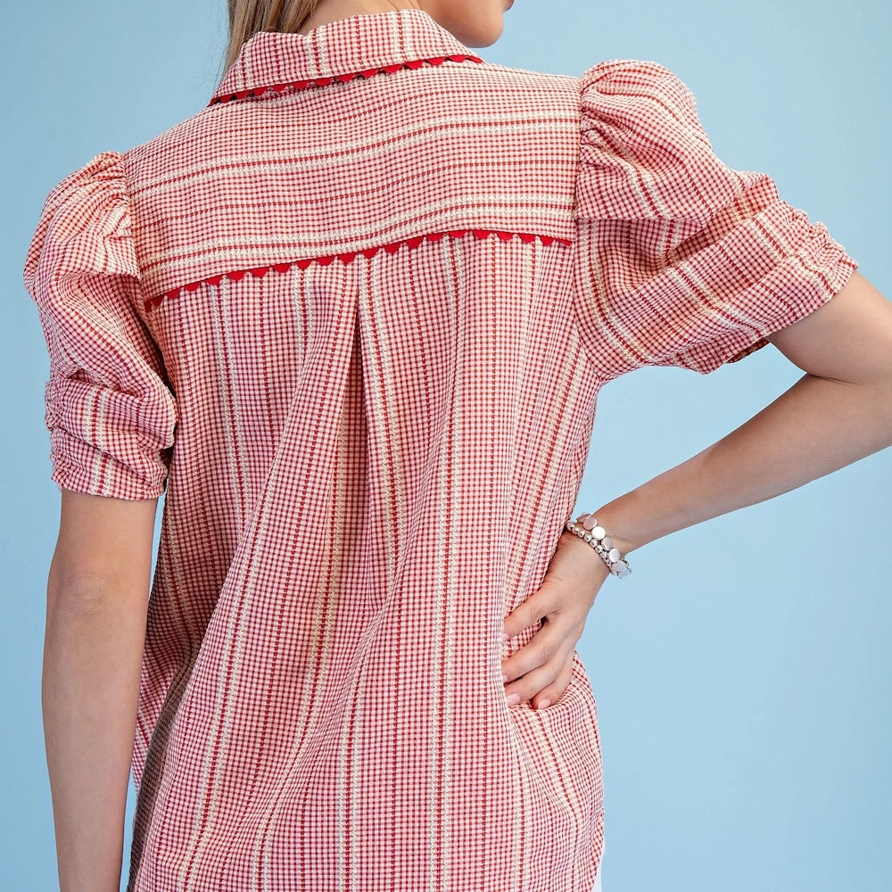 Back view of a red gingham button-down shirt featuring puffed gathered sleeves, a ric-rac trim yoke, and white embroidery.