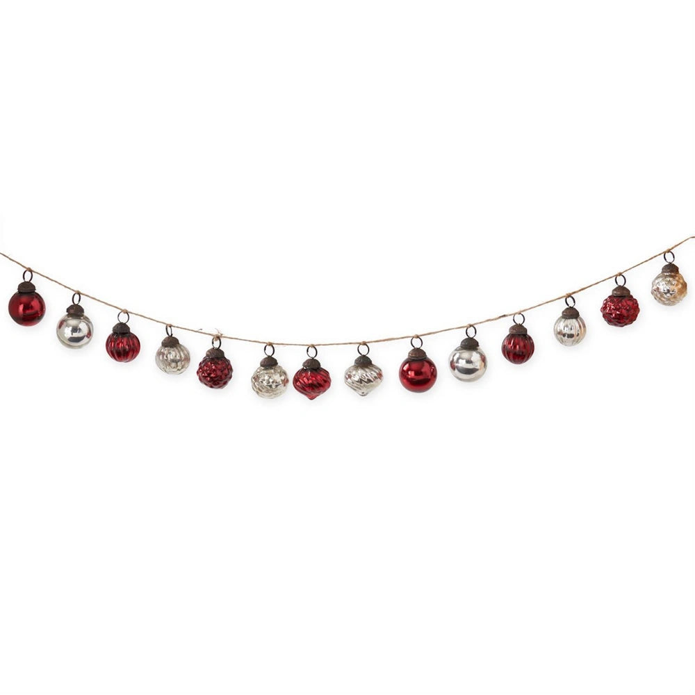 Long garland of assorted red and silver glass Christmas ornaments hung on twine.