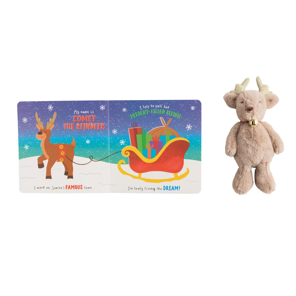 An open children's board book about Comet the Reindeer beside a plush reindeer toy.