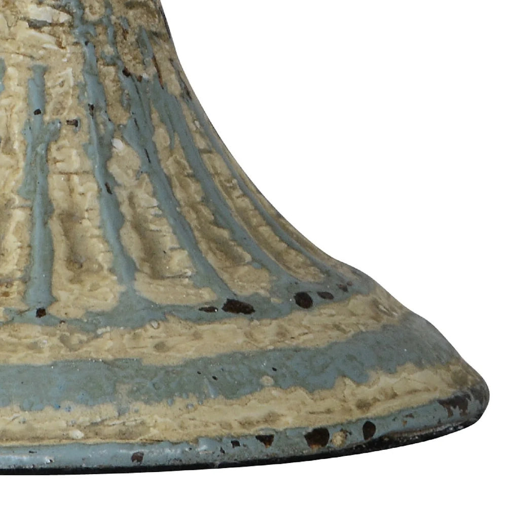 Close-up of a rustic, fluted ceramic base with a weathered blue and cream glazed finish and distressed texture.
