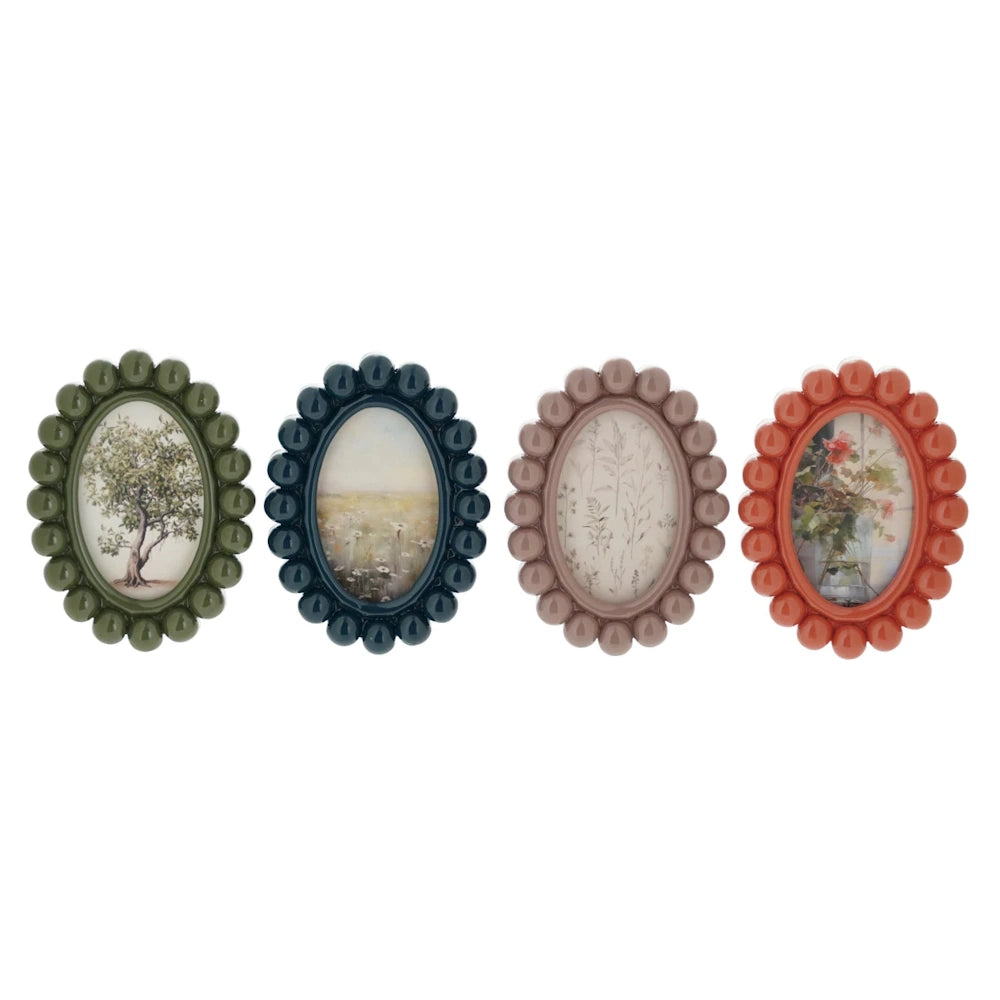 Four small oval resin bobbin photo frame magnets in green, navy, mauve, and terracotta with botanical art prints.