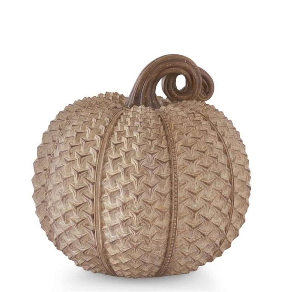 A beige decorative pumpkin with a heavily textured, geometric patterned surface and a curled brown stem.