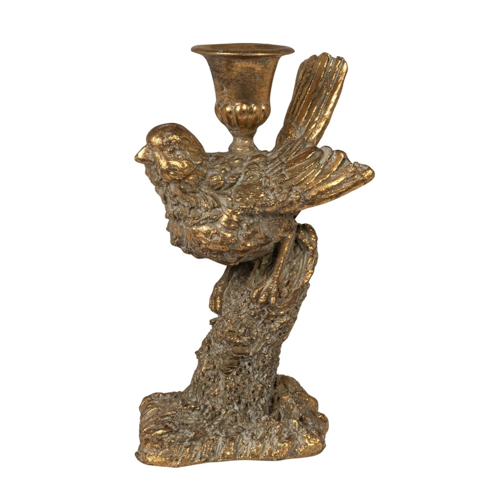 Gold bird-shaped taper candle holder on a textured branch pedestal, rustic resin decor with a vintage metallic finish.