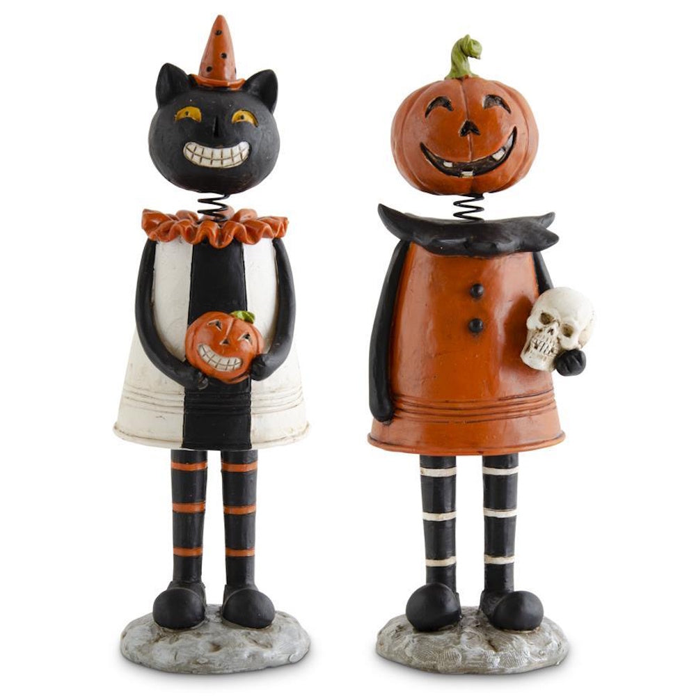 Pair of vintage Halloween bobblehead figurines featuring a black cat and a jack-o'-lantern character.
