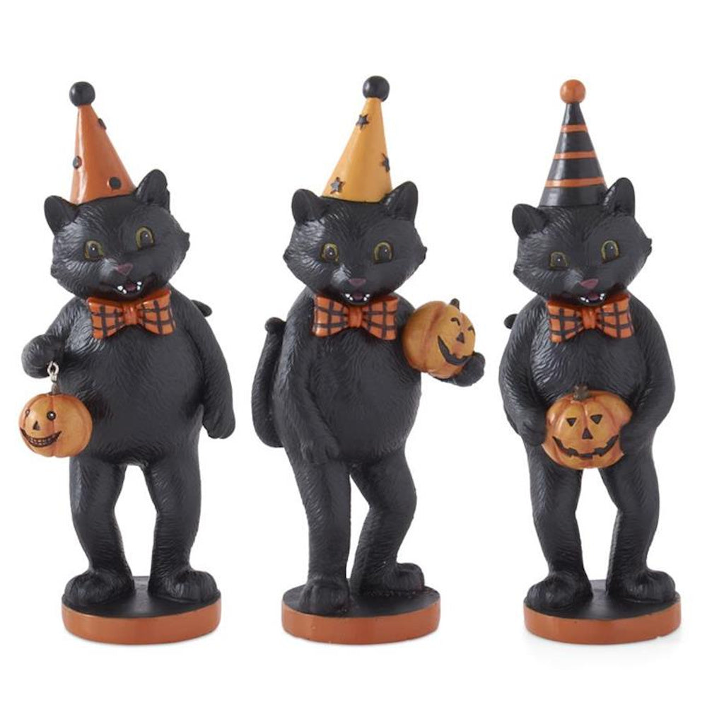 Three vintage-style black cat figurines wearing party hats and bow ties, holding small Halloween pumpkins.