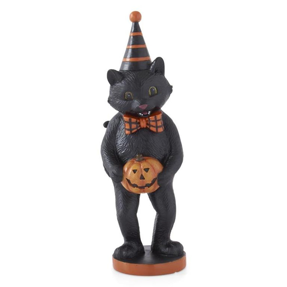 Vintage-style black cat figurine wearing a party hat and bowtie, holding a small jack-o'-lantern.