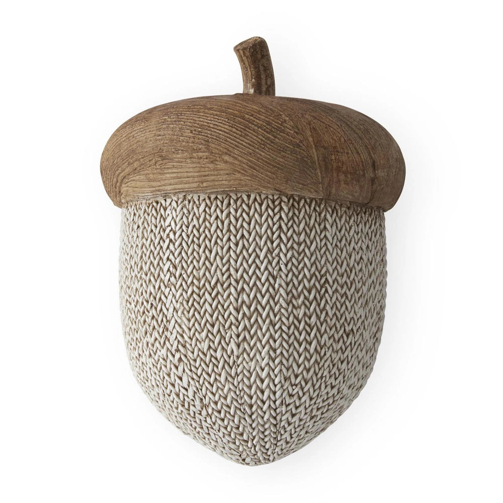 Decorative acorn with brown faux woodgrain cap and white woven knit body for rustic fall decor.