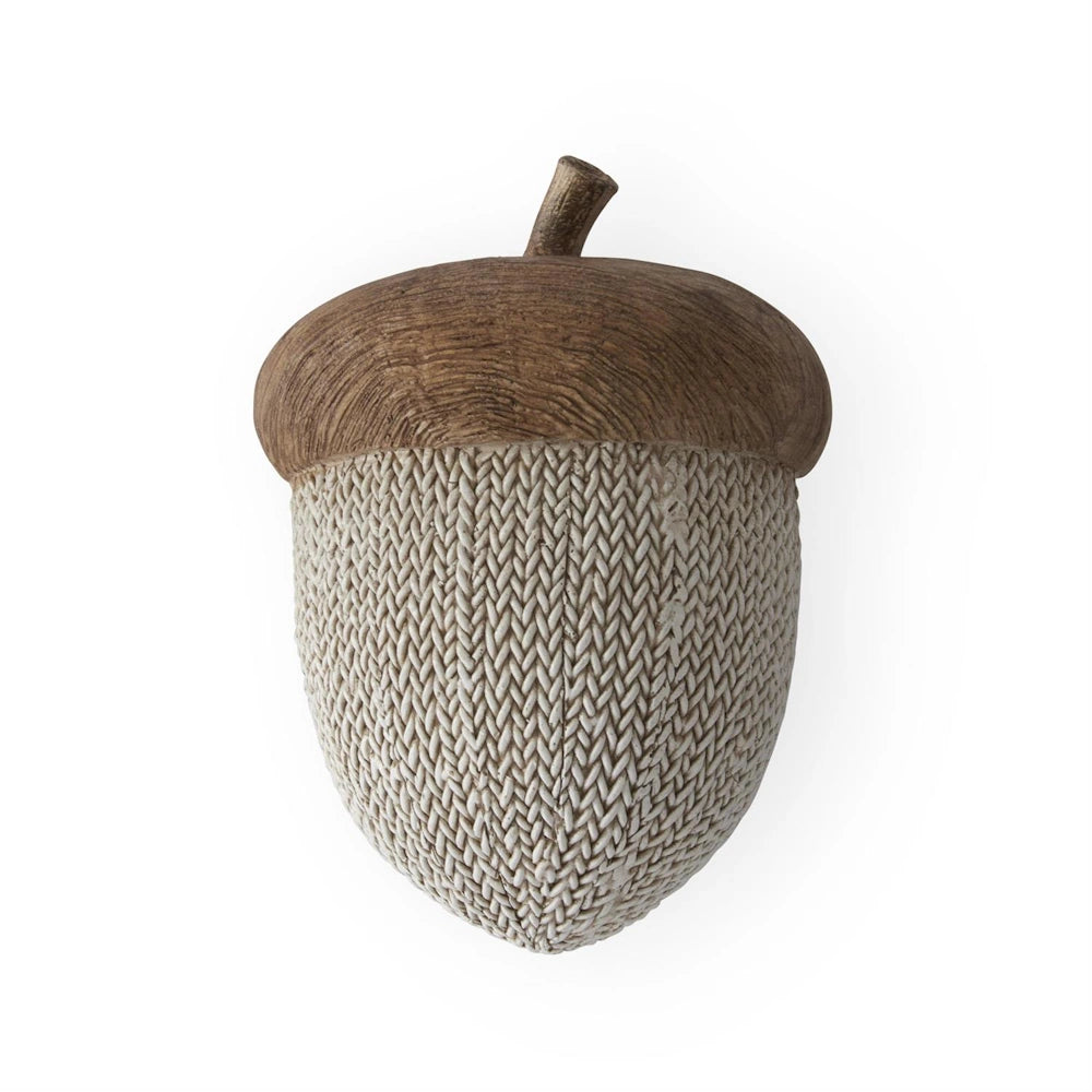 Decorative faux woven and woodgrain resin acorn ornament on a white background.