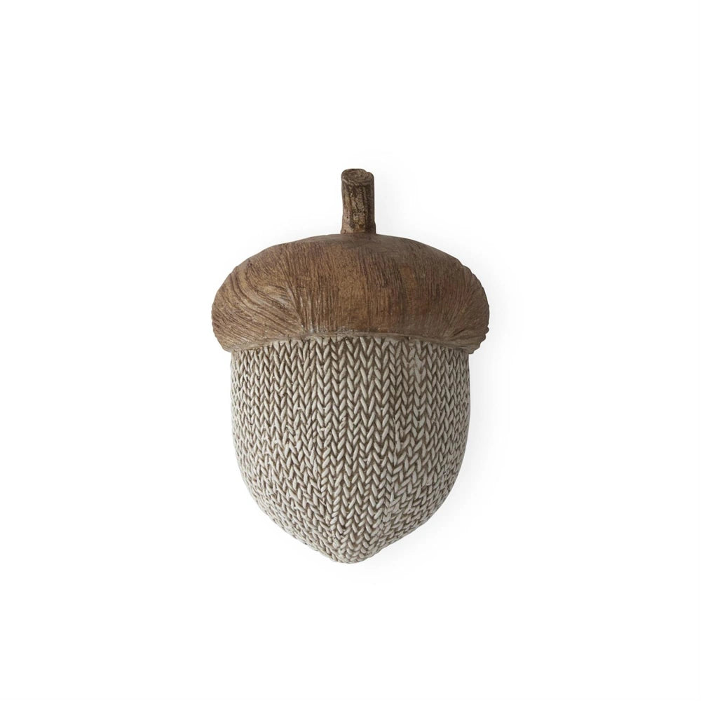 Faux knit and woodgrain resin acorn decorative tabletop ornament.