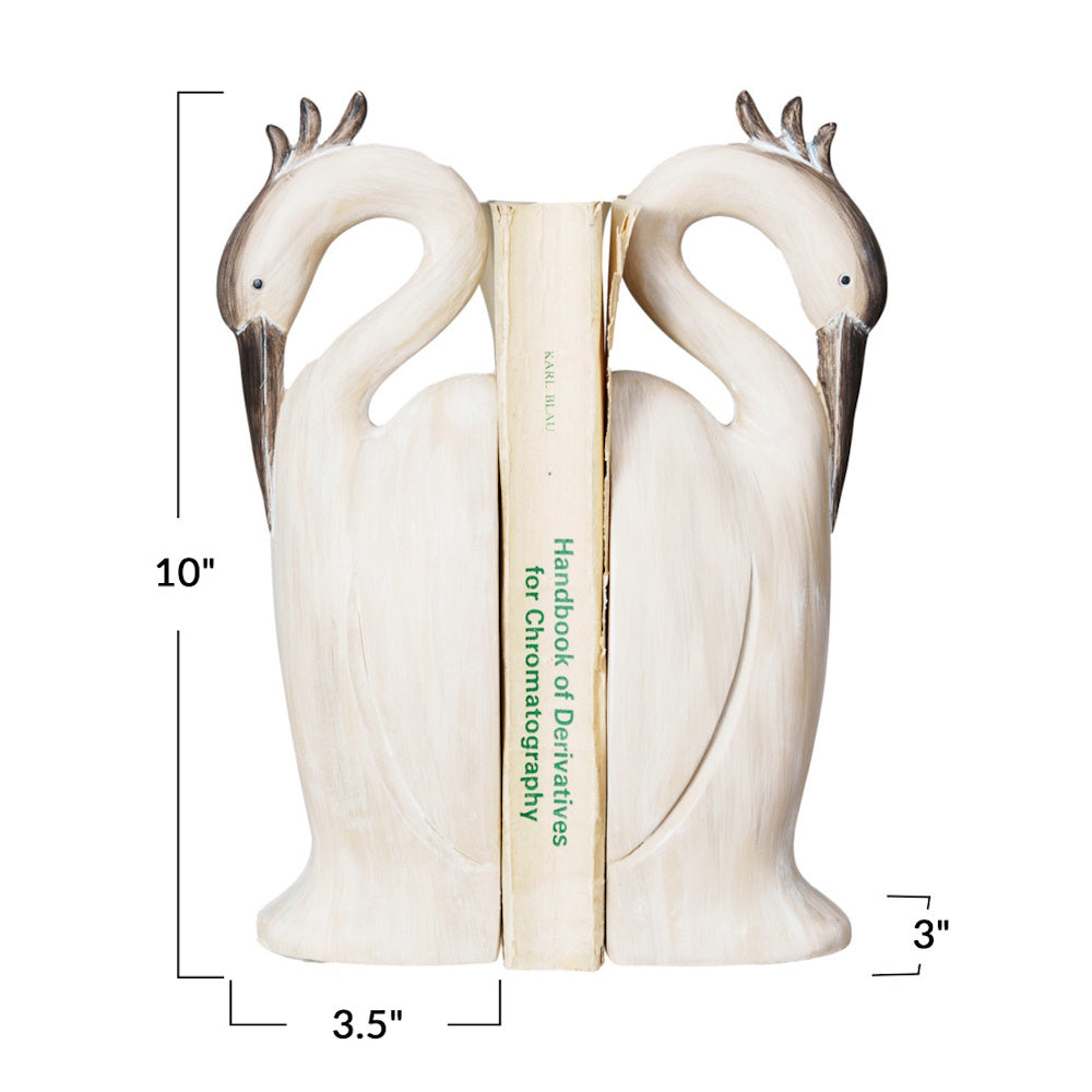 Pair of beige resin heron bookends holding a book, with dimensions labeled: 10" height, 3.5" width, and 3" depth.