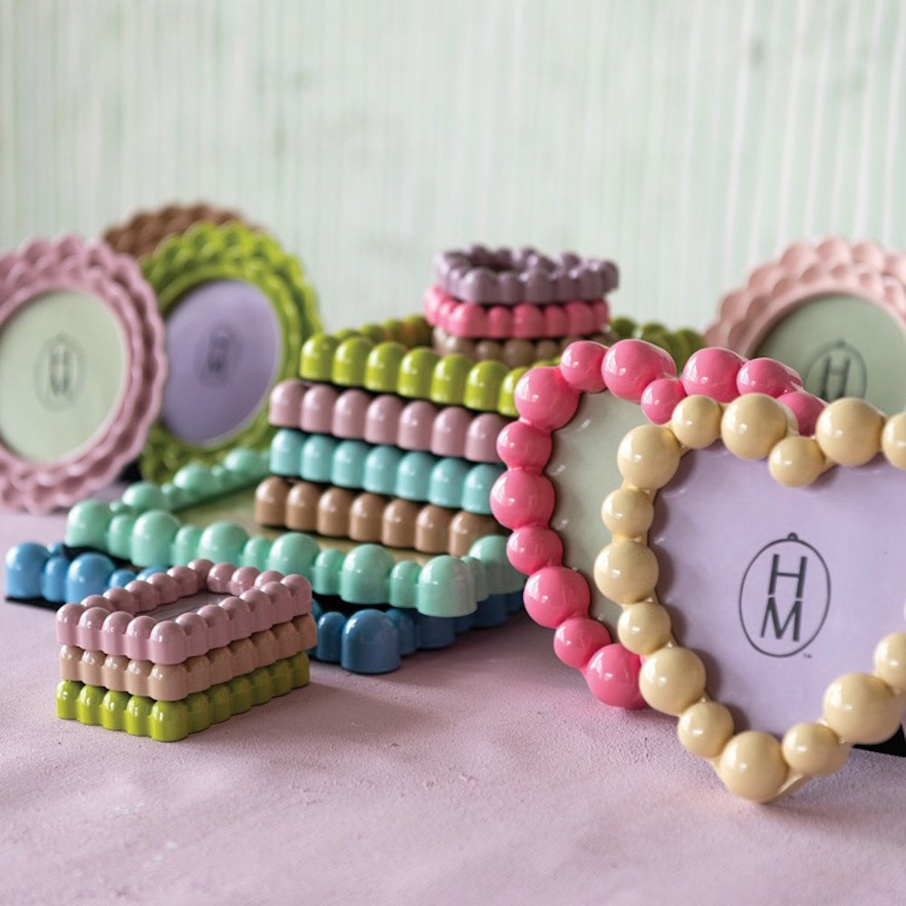 Assorted colorful photo frames with ruffled and bobbin edges in round, heart, and rectangular shapes.