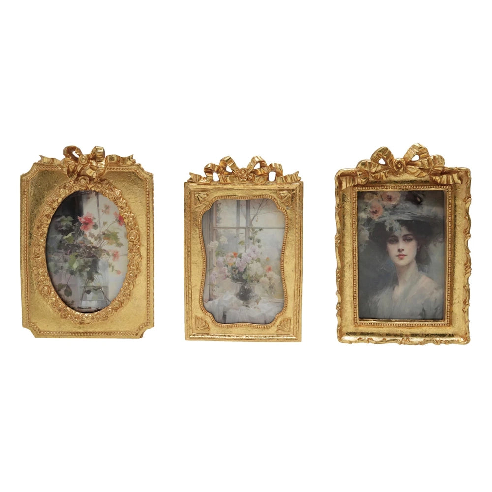 Set of three ornate gold resin photo frames with bows, featuring vintage floral art and a classic portrait.