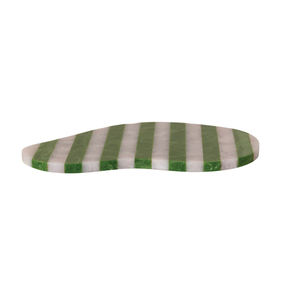Side view of a flat, organic-shaped resin serving board with green and white vertical stripes.