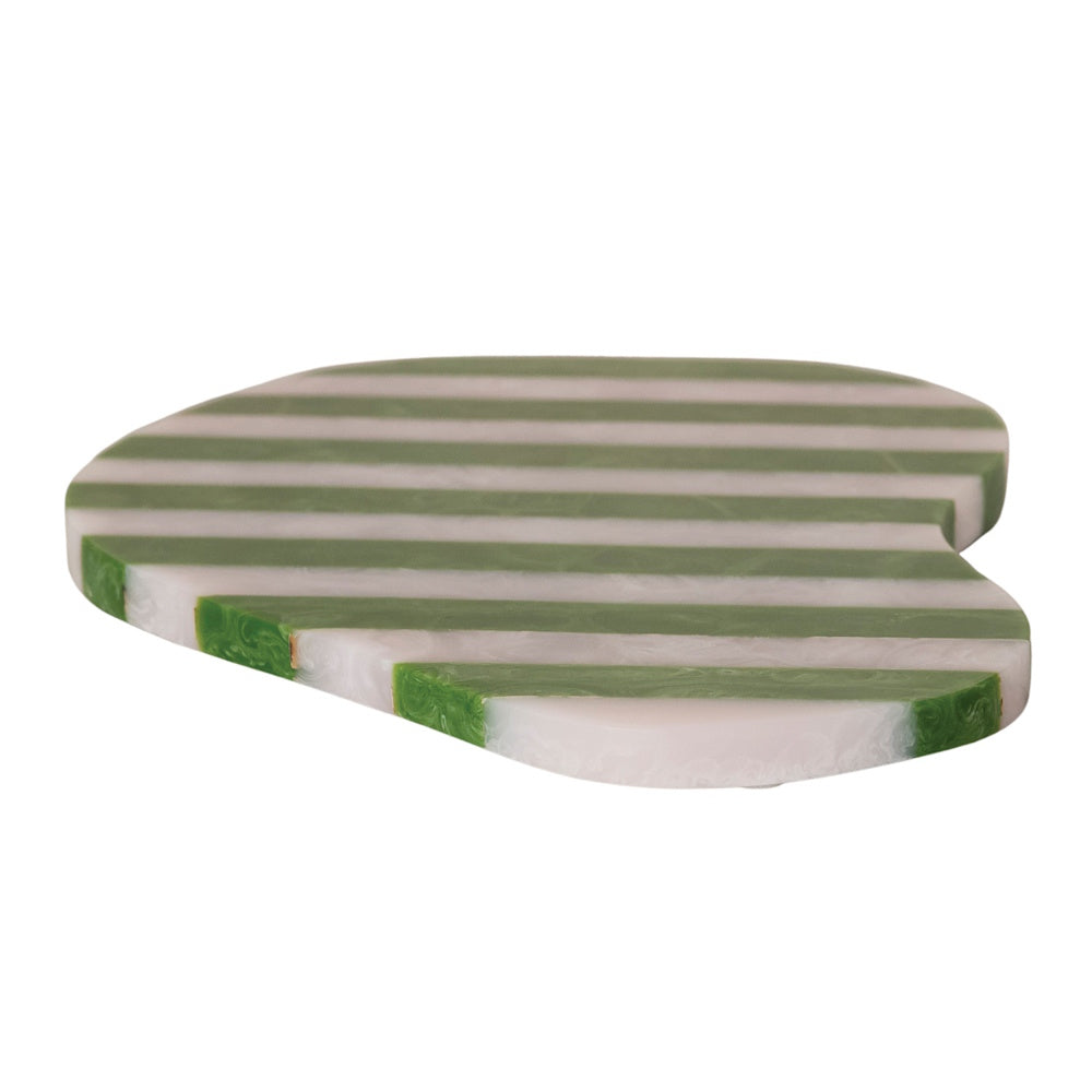 An organically shaped resin serving board with green and white horizontal stripes on white background.