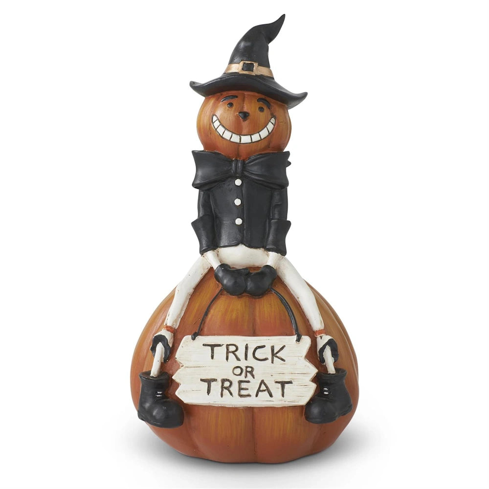 Vintage Halloween pumpkin man figurine wearing a witch hat and sitting on a pumpkin with a Trick or Treat sign.