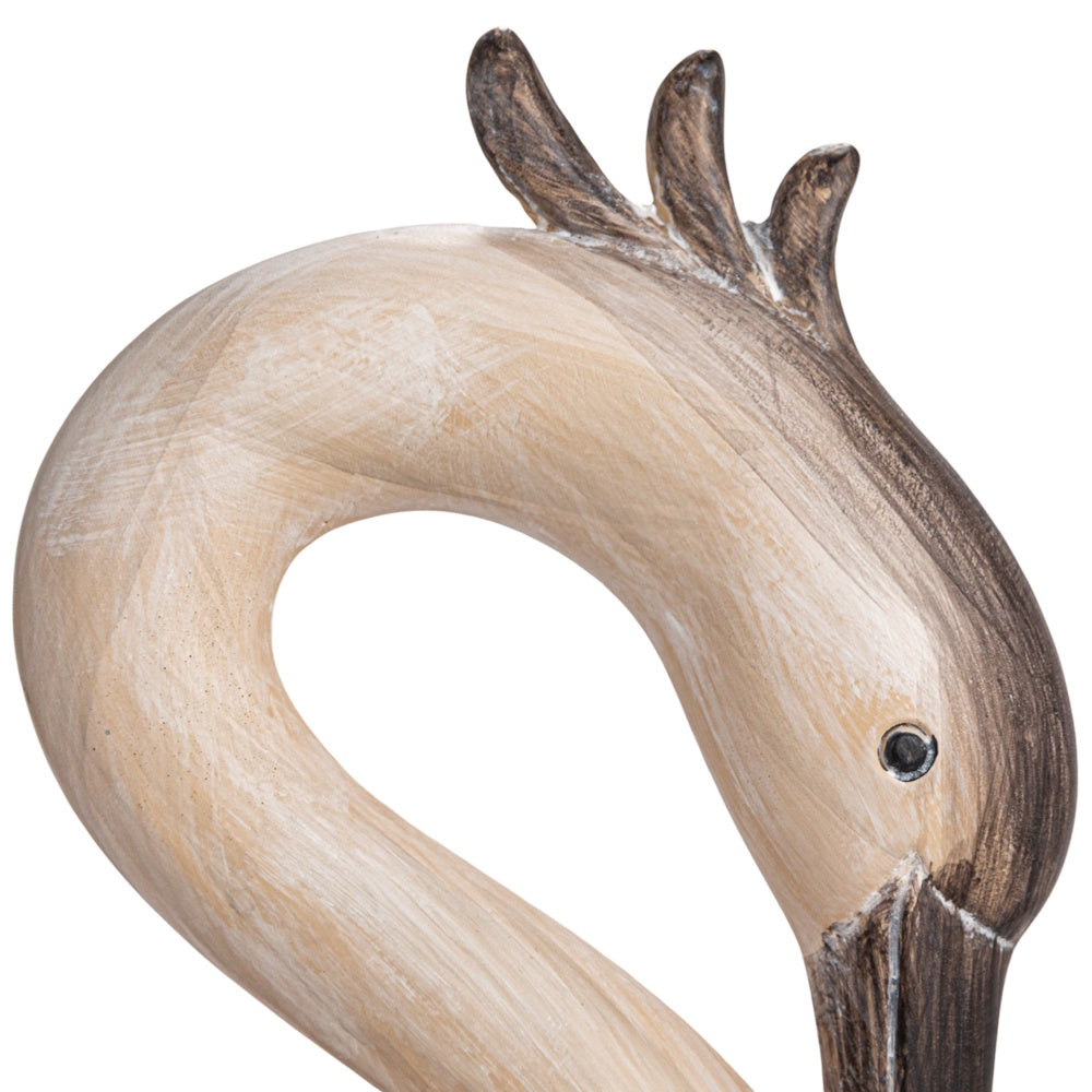 Close-up of a light beige resin heron-shaped bookend head showing carved crown feathers and a dark beak.