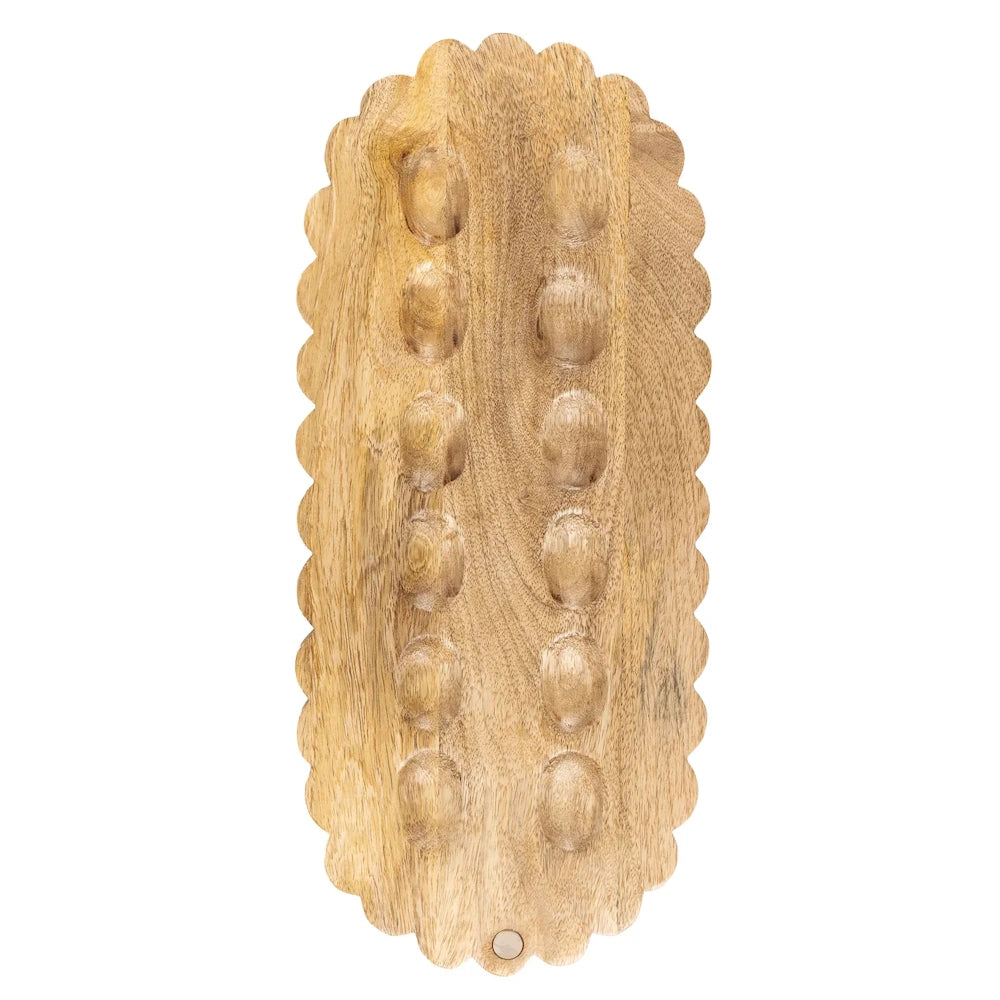 Reversible wooden scalloped bow board with two rows of circular indentations for organizing hair accessories.