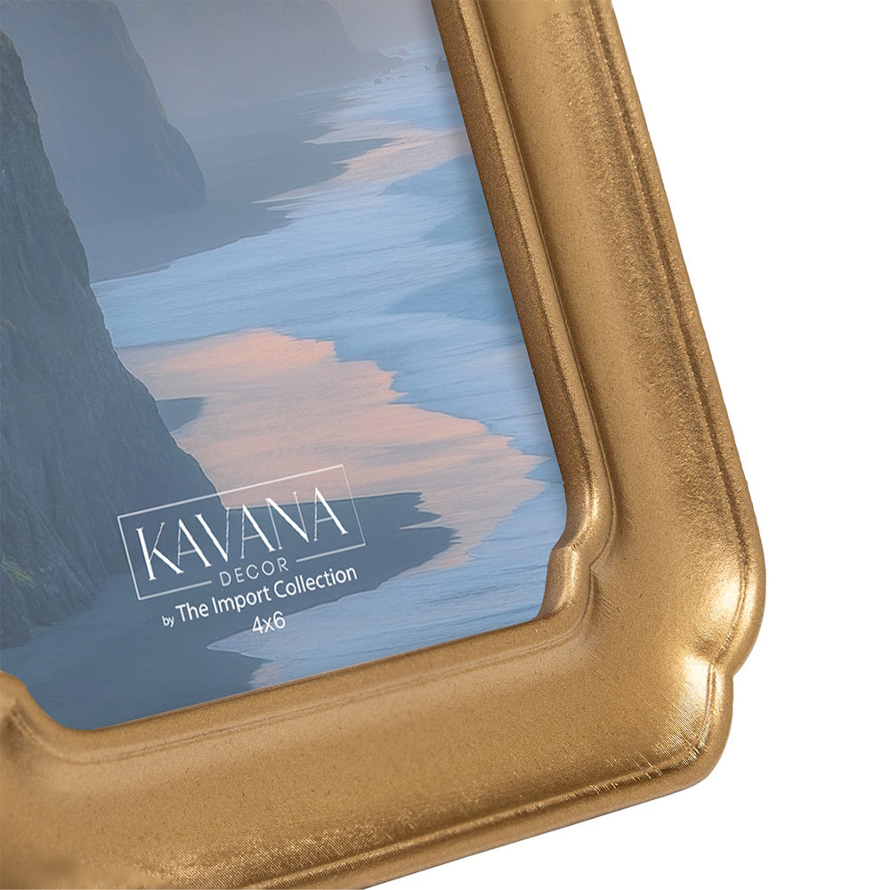 Close-up of a 4x6 Kavana Decor gold picture frame featuring a classic scalloped corner and a scenic coastal landscape.
