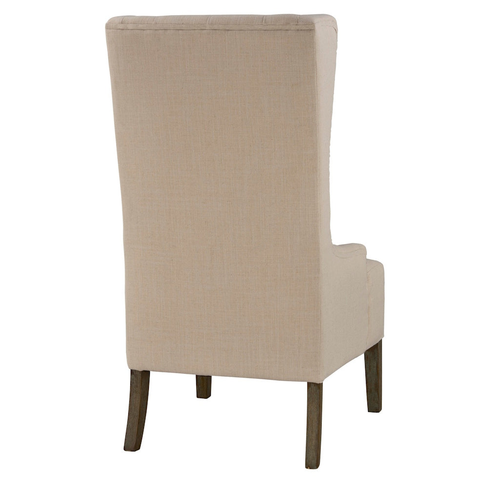 Back view of a beige wingback accent chair with a tall upholstered back and dark wood legs on a white background.