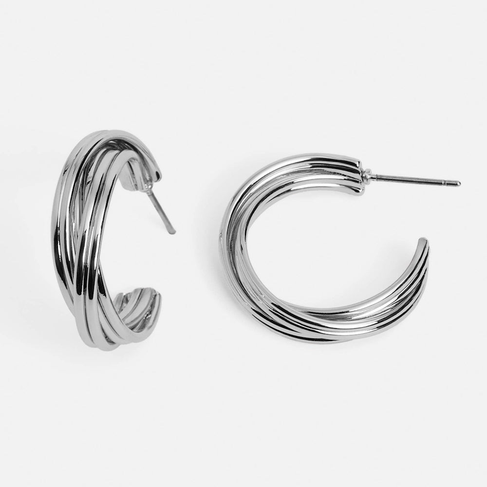 Stacked silver hoop earrings with a multi-ring layered design and a polished metallic finish.