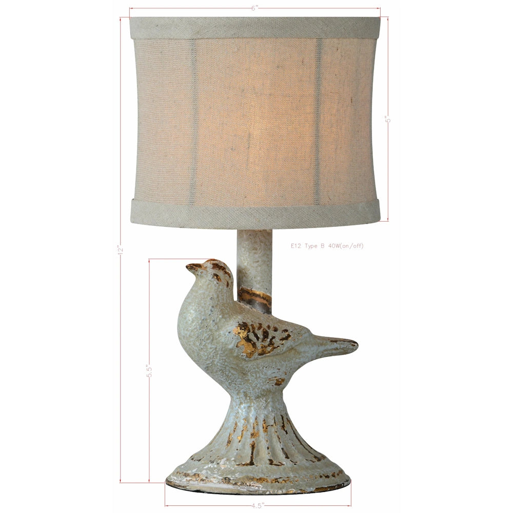 Small vintage-style bird table lamp with linen shade and distressed gold finish base showing 12 inch height dimensions.