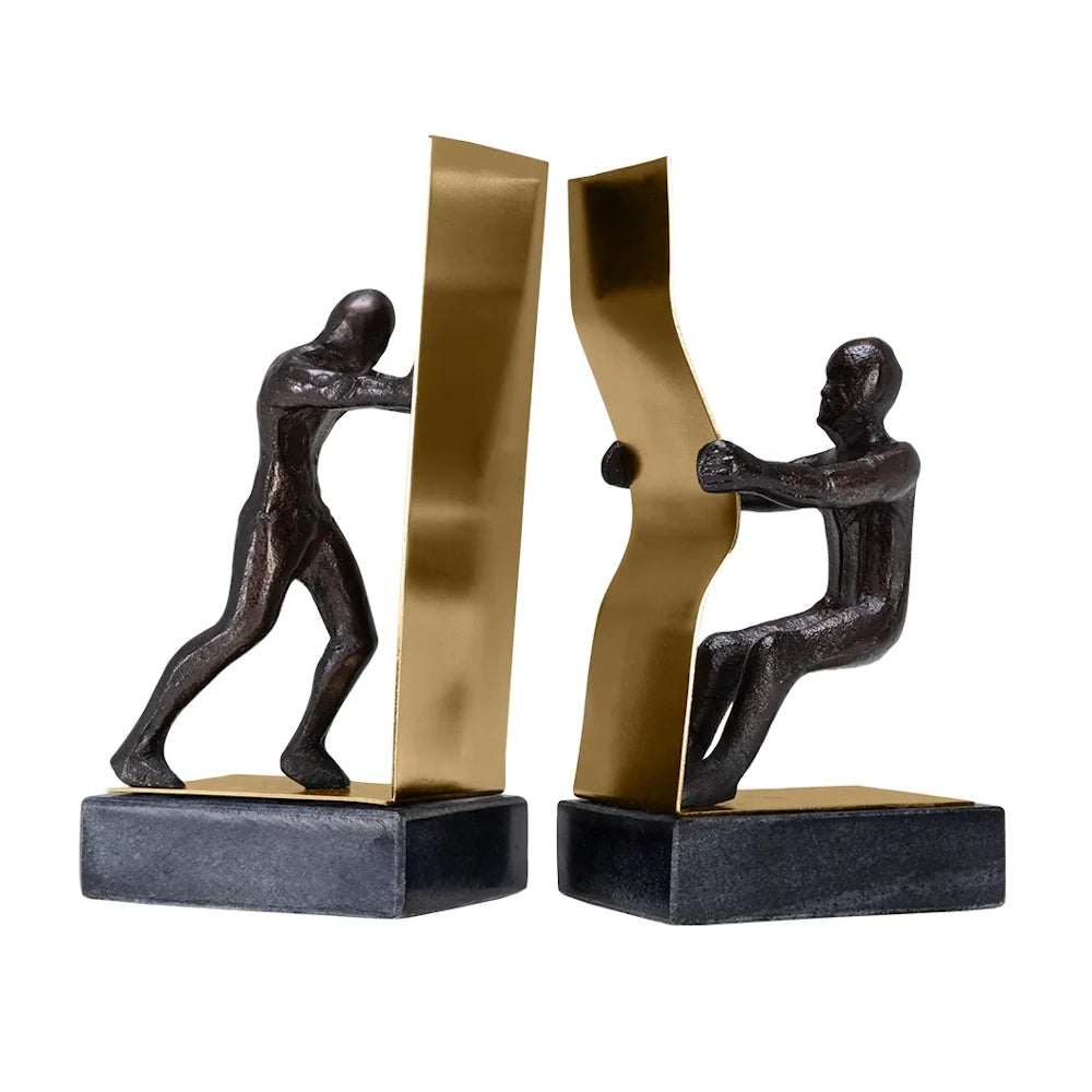 A pair of bookends featuring bronze figures, one pushing a gold plate and the other pulling a curved one.