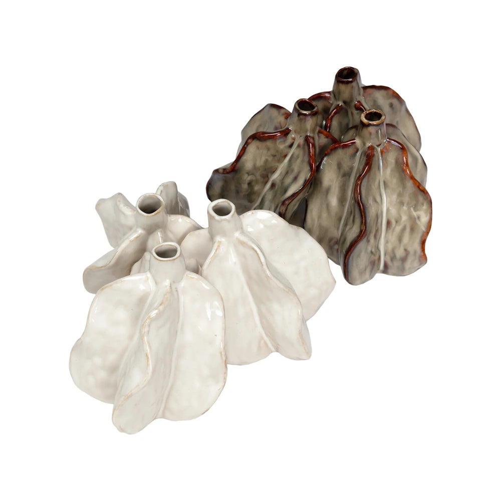 Two organic, multi-necked ceramic vases, one glossy white and one mottled grey-brown, on a white background.