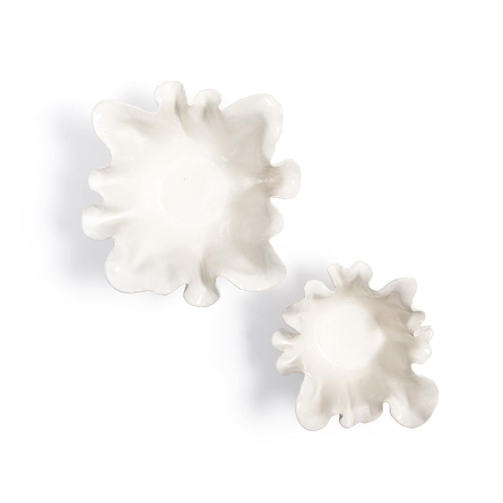 Top-down view of two glossy white ceramic bowls showing their organic, flower-like wavy ruffled rims.