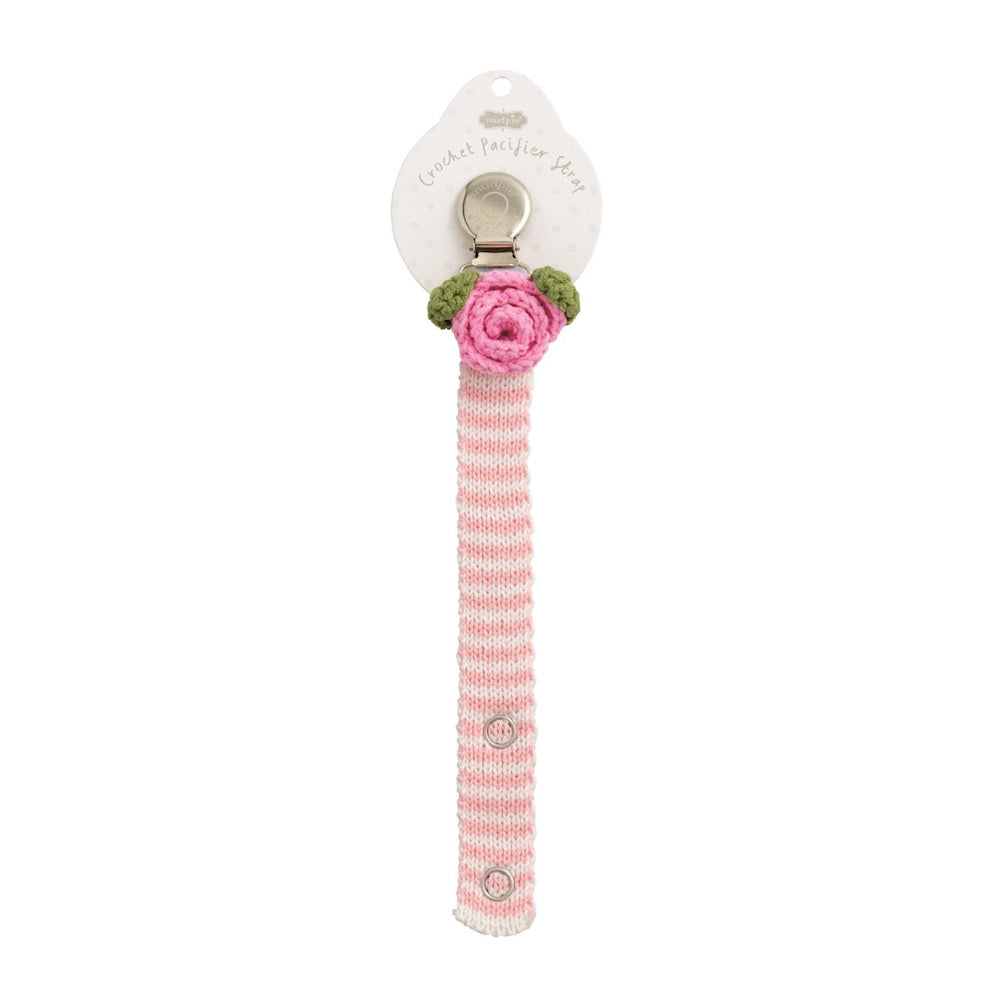 Pink crochet rose pacifier clip with green leaves and a pink and white striped strap on a Mud Pie display card.