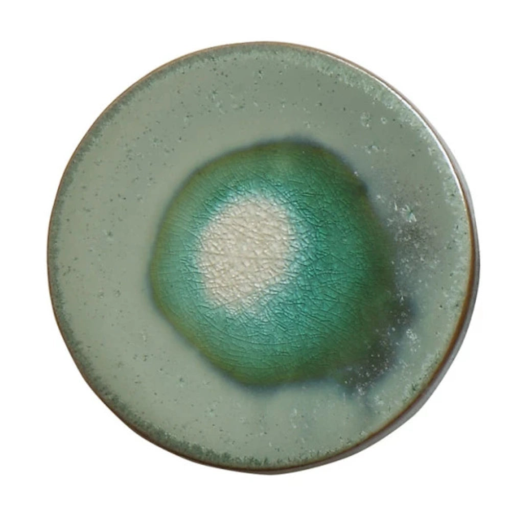 Round stoneware trivet with a crackle glaze finish in shades of sage and emerald green on a white background.