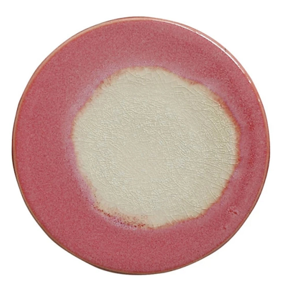 Round pink stoneware trivet with a cream crackle glaze center, ideal for heat-resistant kitchen surface protection.